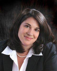 headshot, shoulder length dark hair and dark eyes, wearing a suit