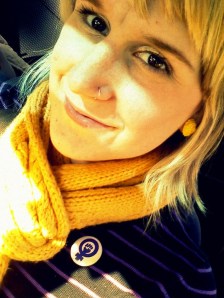 Kristen, smiling with yellow scarf and blond hair