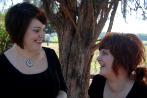 Charlie and Megan together, smiling in front of tree.