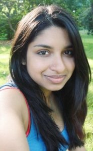 Leila, with long hair, smiling