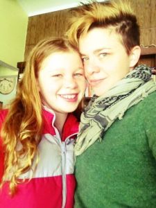 Angela wearing green sweater with a younger person wearing a red jacket