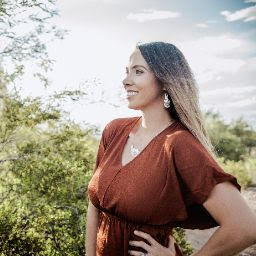 Emily smiling with a nature background